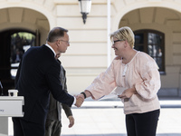 Polish President Andrzej Duda and Lithuanian Prime Minister Ingrida Simonyte shake hands after a joint press conference with Ukraine's Presi...