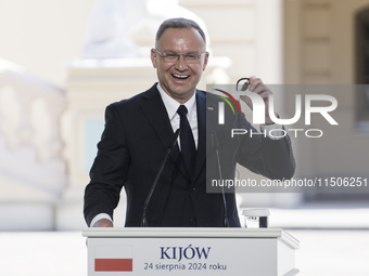 Polish President Andrzej Duda reacts during a joint press conference with Ukrainian President Volodymyr Zelenskiy and Lithuanian Prime Minis...