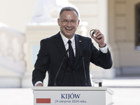 Polish President Andrzej Duda reacts during a joint press conference with Ukrainian President Volodymyr Zelenskiy and Lithuanian Prime Minis...