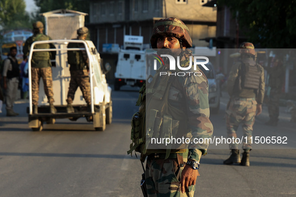 Indian Army soldiers stand alert after an encounter breaks out between militants and security forces in which one militant is killed in Wate...