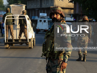 Indian Army soldiers stand alert after an encounter breaks out between militants and security forces in which one militant is killed in Wate...