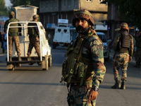 Indian Army soldiers stand alert after an encounter breaks out between militants and security forces in which one militant is killed in Wate...