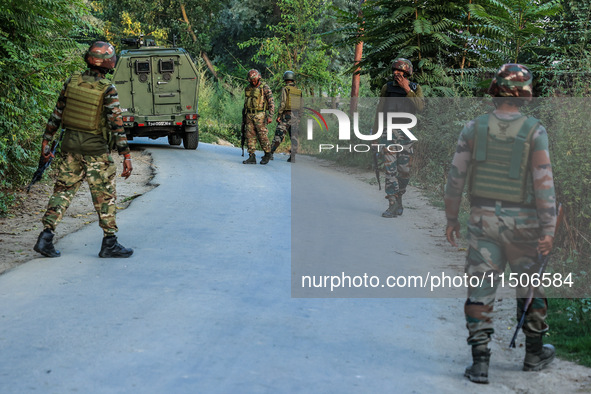 Indian Army soldiers stand alert after an encounter breaks out between militants and security forces in which one militant is killed in Wate...