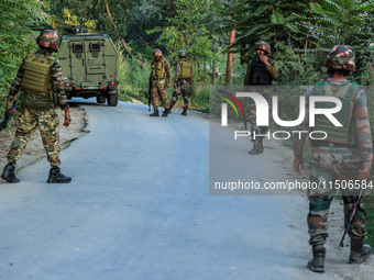 Indian Army soldiers stand alert after an encounter breaks out between militants and security forces in which one militant is killed in Wate...