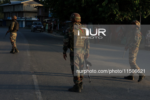 Indian Army soldiers stand alert after an encounter breaks out between militants and security forces in which one militant is killed in Wate...