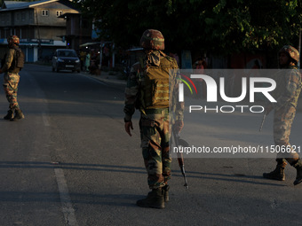 Indian Army soldiers stand alert after an encounter breaks out between militants and security forces in which one militant is killed in Wate...