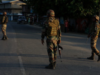 Indian Army soldiers stand alert after an encounter breaks out between militants and security forces in which one militant is killed in Wate...