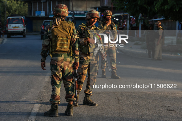 Indian Army soldiers stand alert after an encounter breaks out between militants and security forces in which one militant is killed in Wate...