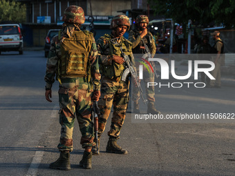 Indian Army soldiers stand alert after an encounter breaks out between militants and security forces in which one militant is killed in Wate...