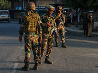 Indian Army soldiers stand alert after an encounter breaks out between militants and security forces in which one militant is killed in Wate...