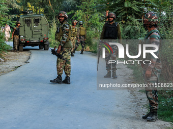 Indian Army soldiers stand alert after an encounter breaks out between militants and security forces in which one militant is killed in Wate...