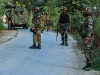 Indian Army soldiers stand alert after an encounter breaks out between militants and security forces in which one militant is killed in Wate...