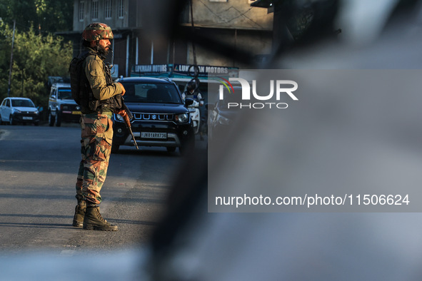 Indian Army soldiers stand alert after an encounter breaks out between militants and security forces in which one militant is killed in Wate...