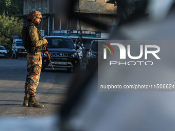 Indian Army soldiers stand alert after an encounter breaks out between militants and security forces in which one militant is killed in Wate...