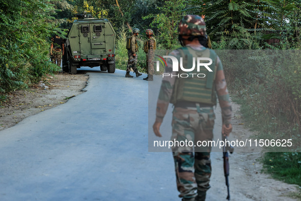 Indian Army soldiers stand alert after an encounter breaks out between militants and security forces in which one militant is killed in Wate...