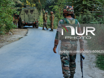 Indian Army soldiers stand alert after an encounter breaks out between militants and security forces in which one militant is killed in Wate...