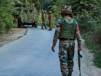 Indian Army soldiers stand alert after an encounter breaks out between militants and security forces in which one militant is killed in Wate...