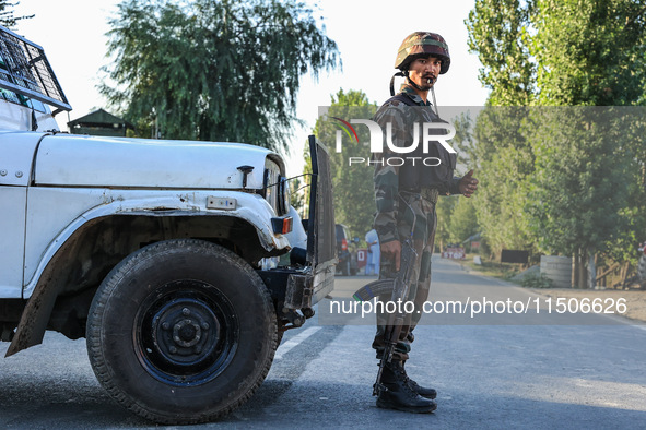 Indian Army soldiers stand alert after an encounter breaks out between militants and security forces in which one militant is killed in Wate...