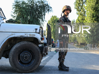 Indian Army soldiers stand alert after an encounter breaks out between militants and security forces in which one militant is killed in Wate...