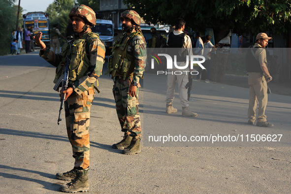 Indian Army soldiers stand alert after an encounter breaks out between militants and security forces in which one militant is killed in Wate...