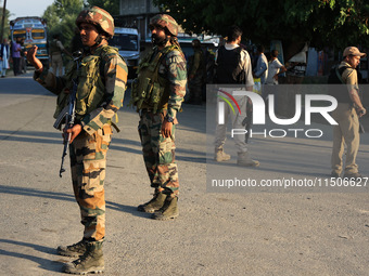 Indian Army soldiers stand alert after an encounter breaks out between militants and security forces in which one militant is killed in Wate...