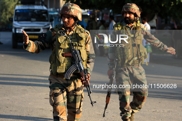 Indian Army soldiers stand alert after an encounter breaks out between militants and security forces in which one militant is killed in Wate...