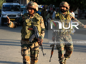 Indian Army soldiers stand alert after an encounter breaks out between militants and security forces in which one militant is killed in Wate...