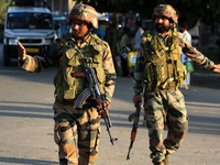 Indian Army soldiers stand alert after an encounter breaks out between militants and security forces in which one militant is killed in Wate...