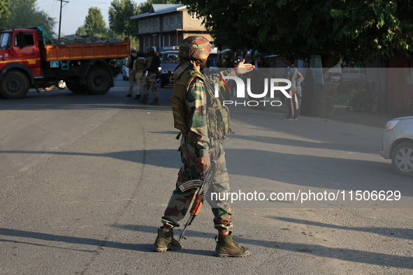 Indian Army soldiers stand alert after an encounter breaks out between militants and security forces in which one militant is killed in Wate...