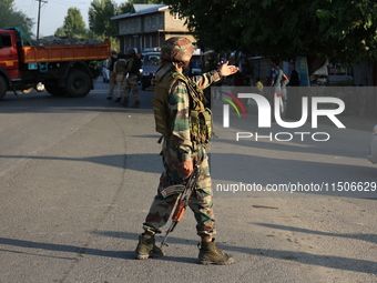 Indian Army soldiers stand alert after an encounter breaks out between militants and security forces in which one militant is killed in Wate...