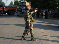 Indian Army soldiers stand alert after an encounter breaks out between militants and security forces in which one militant is killed in Wate...