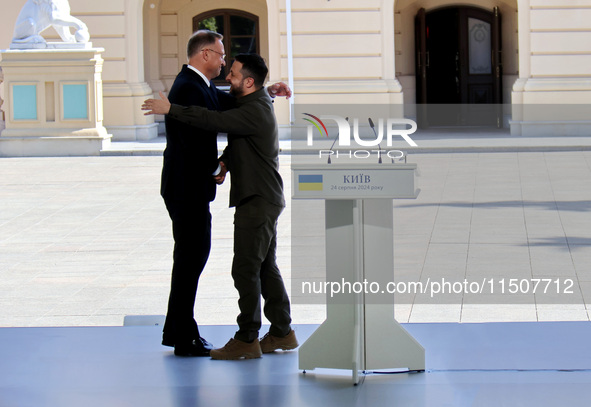 President of Ukraine Volodymyr Zelenskyy hugs President of Poland Andrzej Duda during a joint news conference outside the Mariinskyi Palace...