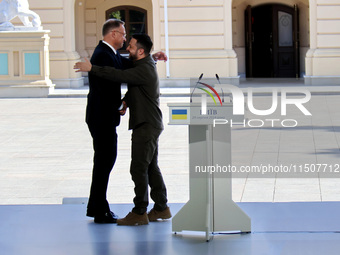 President of Ukraine Volodymyr Zelenskyy hugs President of Poland Andrzej Duda during a joint news conference outside the Mariinskyi Palace...