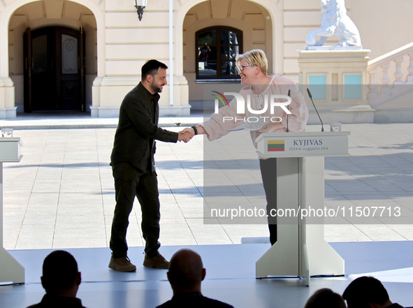 President of Ukraine Volodymyr Zelenskyy (left) shakes hands with Prime Minister of Lithuania Ingrida Simonyte during a joint news conferenc...