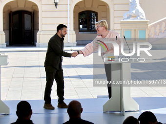 President of Ukraine Volodymyr Zelenskyy (left) shakes hands with Prime Minister of Lithuania Ingrida Simonyte during a joint news conferenc...