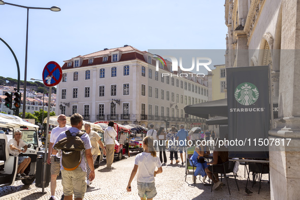 A general view of people walking by a Starbucks Coffee store in Lisbon, Portugal, on August 24, 2024. Brian Niccol, CEO of Starbucks startin...