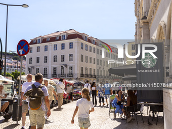 A general view of people walking by a Starbucks Coffee store in Lisbon, Portugal, on August 24, 2024. Brian Niccol, CEO of Starbucks startin...