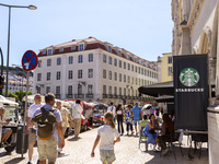 A general view of people walking by a Starbucks Coffee store in Lisbon, Portugal, on August 24, 2024. Brian Niccol, CEO of Starbucks startin...