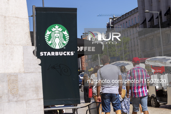 A general view of people walking by a Starbucks Coffee store in Lisbon, Portugal, on August 24, 2024. Brian Niccol, CEO of Starbucks startin...