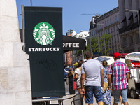 A general view of people walking by a Starbucks Coffee store in Lisbon, Portugal, on August 24, 2024. Brian Niccol, CEO of Starbucks startin...