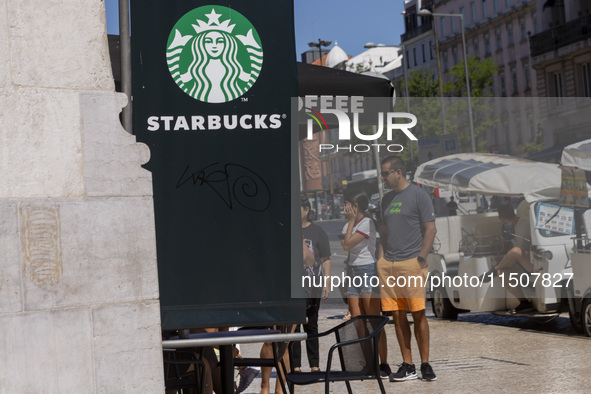 A general view of people walking by a Starbucks Coffee store in Lisbon, Portugal, on August 24, 2024. Brian Niccol, CEO of Starbucks startin...