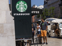 A general view of people walking by a Starbucks Coffee store in Lisbon, Portugal, on August 24, 2024. Brian Niccol, CEO of Starbucks startin...