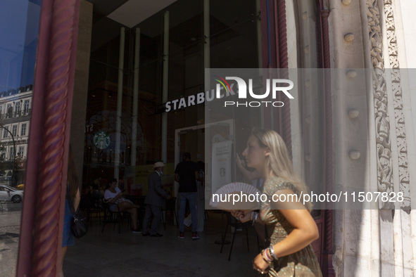 A general view of people walking by a Starbucks Coffee store in Lisbon, Portugal, on August 24, 2024. Brian Niccol, CEO of Starbucks startin...