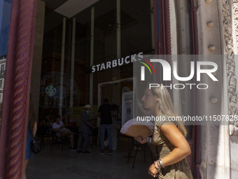 A general view of people walking by a Starbucks Coffee store in Lisbon, Portugal, on August 24, 2024. Brian Niccol, CEO of Starbucks startin...