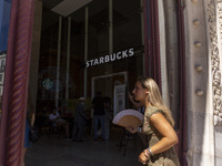 A general view of people walking by a Starbucks Coffee store in Lisbon, Portugal, on August 24, 2024. Brian Niccol, CEO of Starbucks startin...