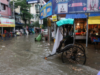 Rickshaw pullers wait for customers during a water-logged street after heavy monsoon rain in Kolkata, India, on August 24, 2024. (