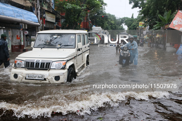 A Mahindra Bolero car drives through a water-logged street after heavy monsoon rain in Kolkata, India, on August 24, 2024. 