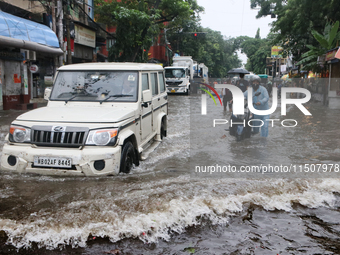 A Mahindra Bolero car drives through a water-logged street after heavy monsoon rain in Kolkata, India, on August 24, 2024. (