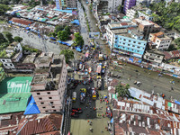 An aerial view shows volunteers transporting relief materials for flood-affected people in the Mohipal area of Feni district in Chittagong d...