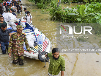 Volunteers and Bangladesh army personnel transport relief material for flood-affected people in Feni district in Chittagong division, Bangla...